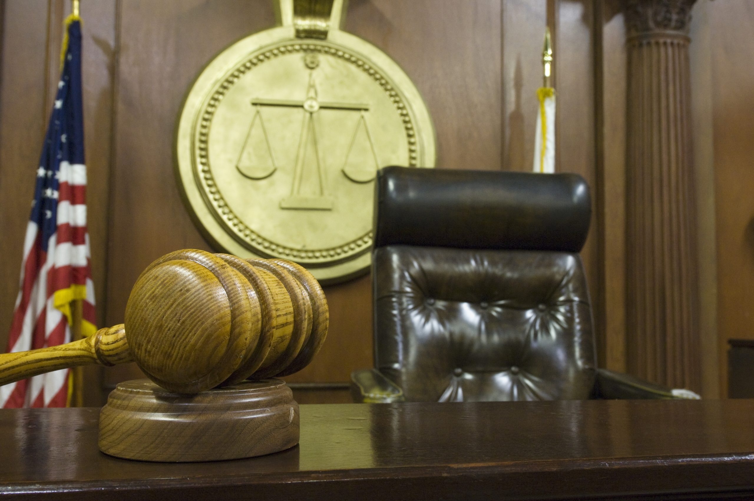 Hammer and gavel near judges chair in court